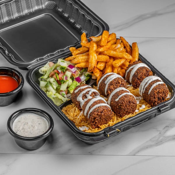 Halal falafel platter with rice, fries, salad, and sauces in a black takeout container.